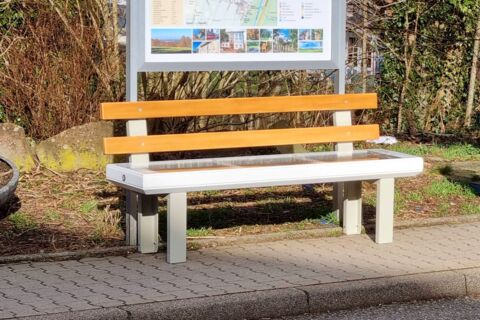 A bright pink sheet of paper used to wrap flowers curves in front of rich blue background